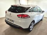 the rear end of a white car parked in a garage