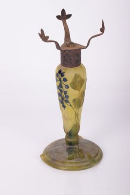 un vase en verre orné d'un arbre, posé sur un socle