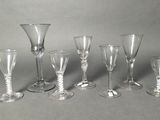 six wine glasses and a wine glass on a table