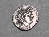 a close up of a silver coin with a man ' s head on it