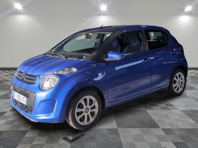 a picture of a blue car parked on a checkered floor