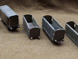 several toy trains are lined up in a row on a table