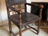 a wooden chair that is sitting in front of a fire place