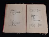 two pages of a book with drawings on them on a table