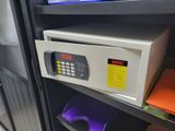 a safe box on a shelf next to a monitor