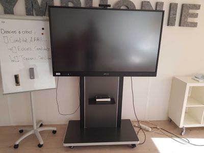 a flat screen tv sitting on a stand in a room