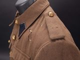 a brown uniform with buttons and buttons on a mannequin