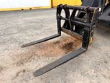 a close up of a fork on a forklift in front of a building
