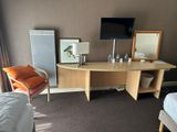 a desk with a mirror and a chair in a room