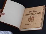 a person holding a book with a picture of a heart on it