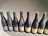 six bottles of wine are lined up in a row on a table