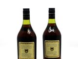 two bottles of liquor sitting next to each other on a white surface