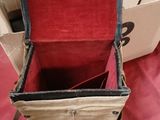 a red and black bag sitting on top of a red table