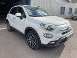 a white fiat suv parked in front of a building