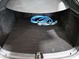 the trunk of a car with a blue hose in the trunk