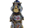 an image of a decorative figurine of a man sitting on top of a clock