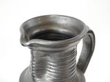 a silver vase that is sitting on a table