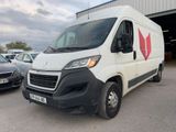 a picture of a white van parked in front of a building