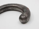 a close up of a metal object on a white surface