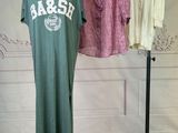 three shirts hanging on a clothes rack in a room