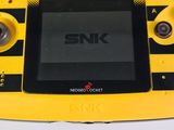 a yellow and black game console sitting on a table