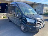 the black van is parked in front of a building
