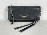 a black leather purse with a gold wing on it