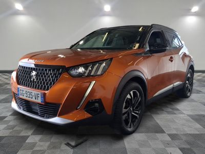 the orange suv is parked in the garage on a checkered floor