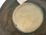 a brown vase with writing on it sitting on a table