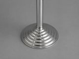 a close up of a silver candle holder on a table
