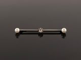 an image of a pearl nose piercing on a black surface