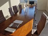 tables and chairs in a conference room with a view of the city
