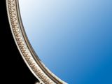 a mirror with a blue sky in the background