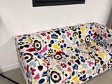 a couch that has a colorful floral pattern on it