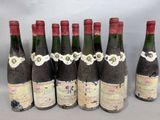 six bottles of wine are lined up in a row on a table