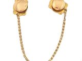 pair of gold tone earrings with chain and flower design