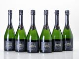 six bottles of champagne are lined up in a row