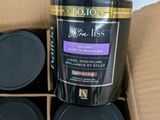 four bottles of coffee sitting in a cardboard box