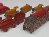 a lot of toy trains that are sitting on a table