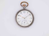 a close up of an old pocket watch on a white surface