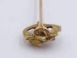 a close up of a gold plated object on a white surface