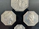 three silver coins with a picture of a woman and a man on them