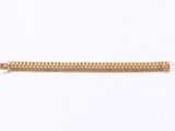 a close up of a gold chain bracelet on a white background