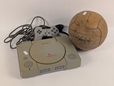 un ballon de foot et une console de jeux vidéo posés sur une table