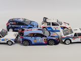 several toy cars are lined up in a row on a white surface