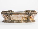 silver plated bathtub with two lions on the sides of the tub