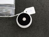 a small black and white ring with a diamond in it