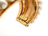 an image of a close up of a bracelet with pearls on it