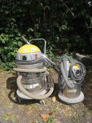 two vacuums that are sitting on the ground next to each other