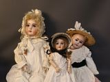 three dolls that are sitting next to each other